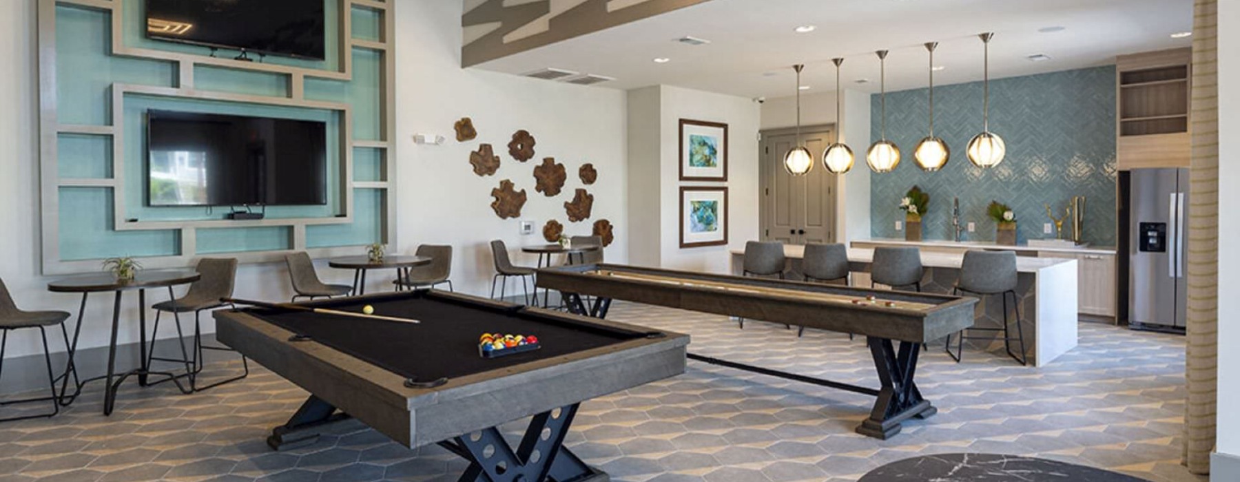 a room with a pool table and tables and chairs