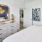 a bedroom with a large bed and mirror and closet