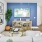 a living room with a blue wall a tv and couch