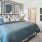 a bedroom with a bed and a fan
