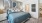 a bedroom with a bed and a fan