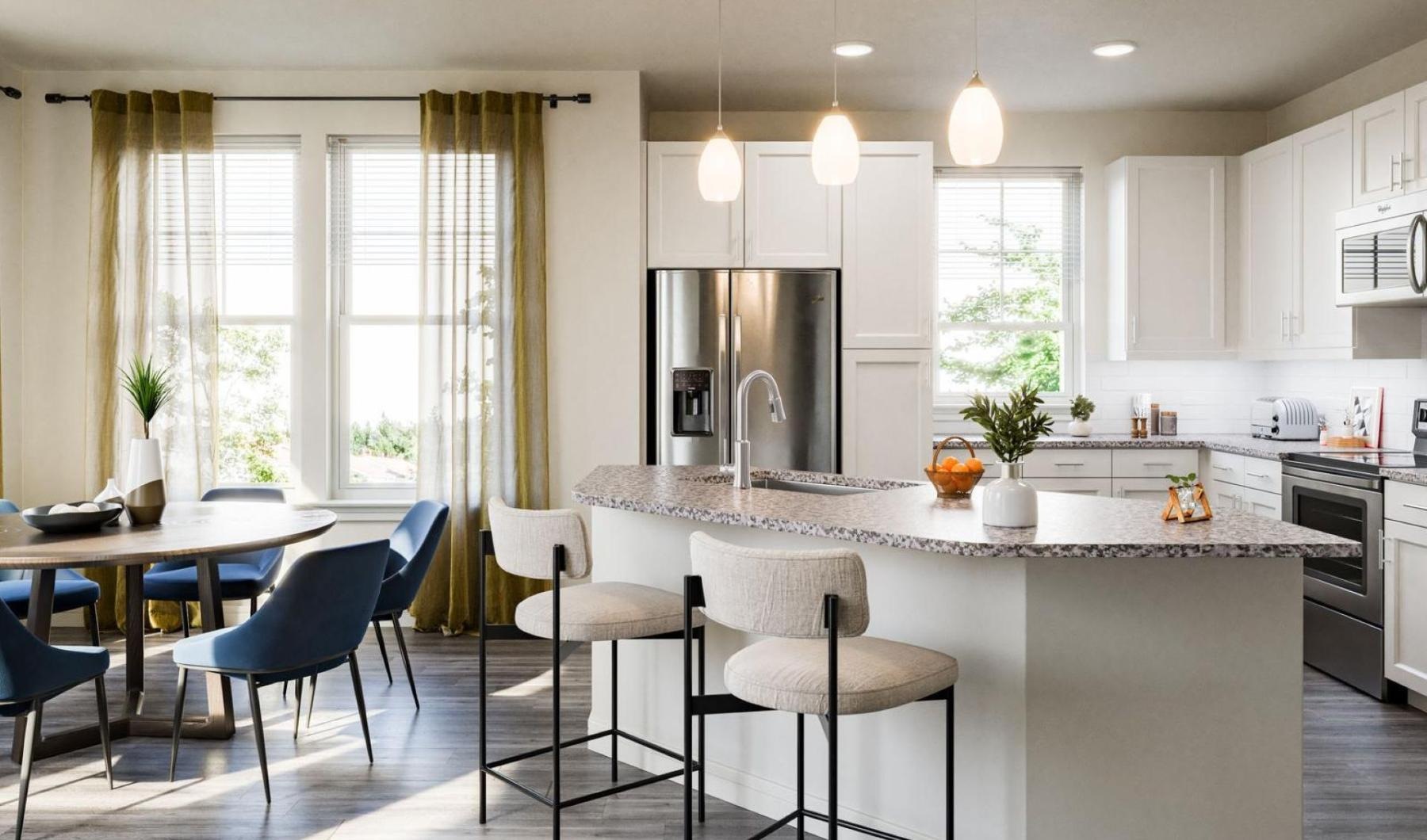 a kitchen with a dining table and chairs and a kitchen island