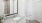 a bathroom with a granite countertop and large mirror