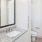 a bathroom with a granite countertop and large mirror