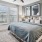 a bedroom with a large bed and a fan and windows