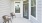 a patio with chairs and windows