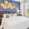 a bedroom with a bed and a fan and windows