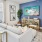 a living room with a couch and a table and tv and a window