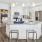 a kitchen with white cabinets and a kitchen island with a granite countertop