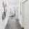 a hallway with white walls leading into a living space