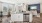a kitchen with a large island with a sink and dishwasher with a dining area