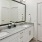 a bathroom with a large mirror and twin sinks