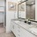 a bathroom with a large mirror twin sinks and a tub