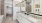 a bathroom with a large mirror twin sinks and a tub