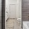 a bathroom with a glass shower a tub and a toilet