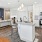 a kitchen with white cabinets and granite countertops and a kitchen island